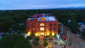 A large, multi-story building with a prominent entrance and a courtyard. - Bagan View Hotel (Nyaung-U)