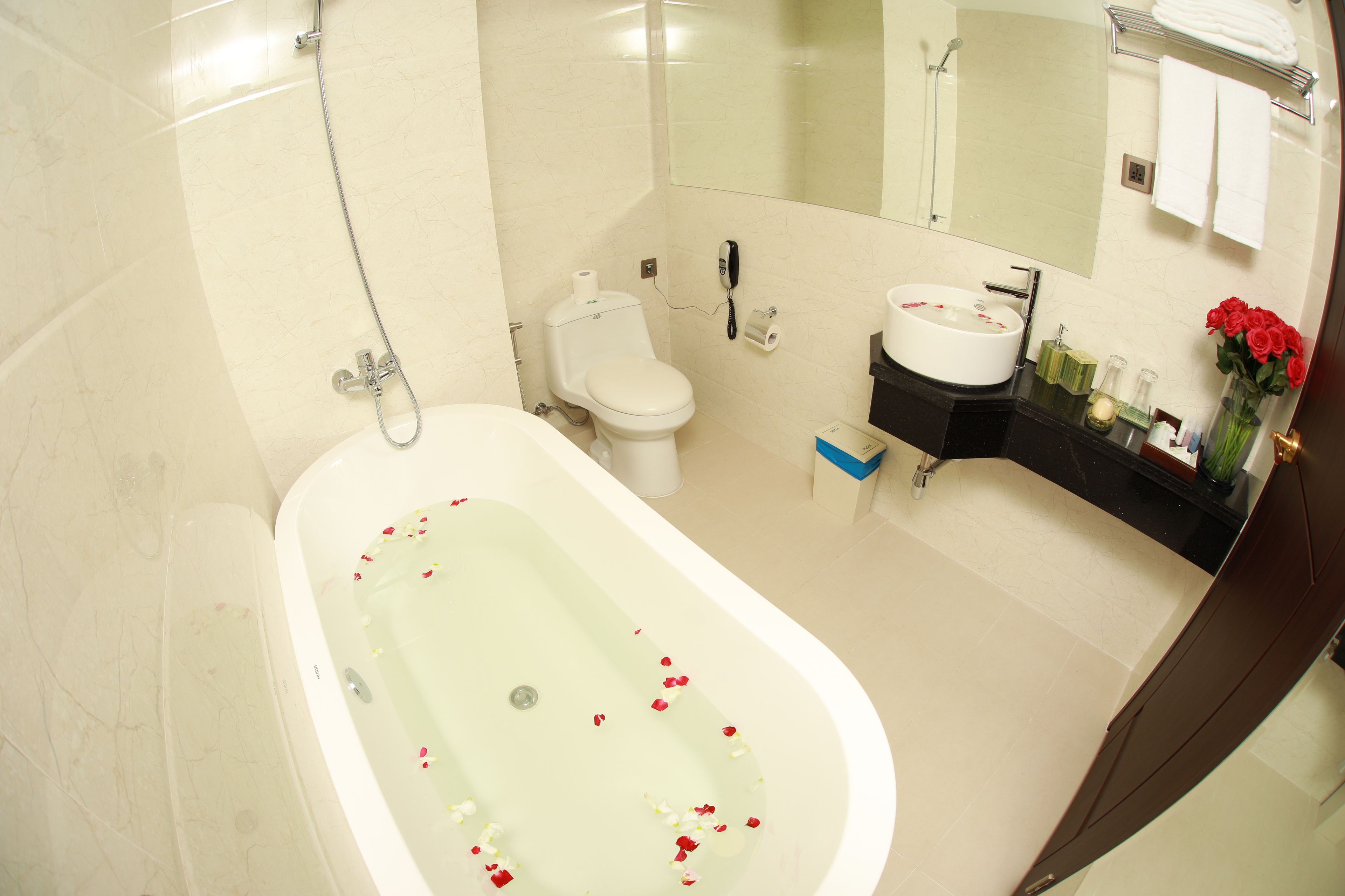 A modern bathroom with a freestanding bathtub, toilet, and vanity.