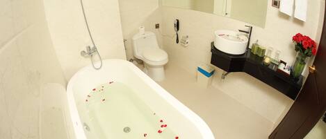 A modern bathroom with a freestanding bathtub, toilet, and vanity.