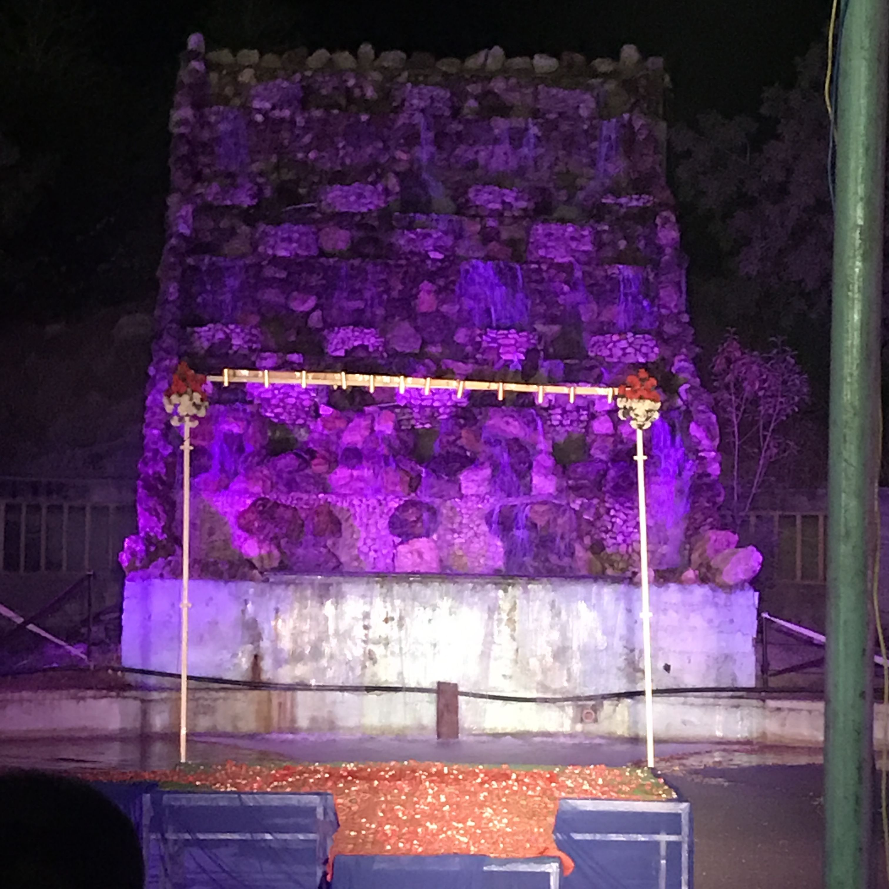 A stone structure with a wooden platform and a metal railing.