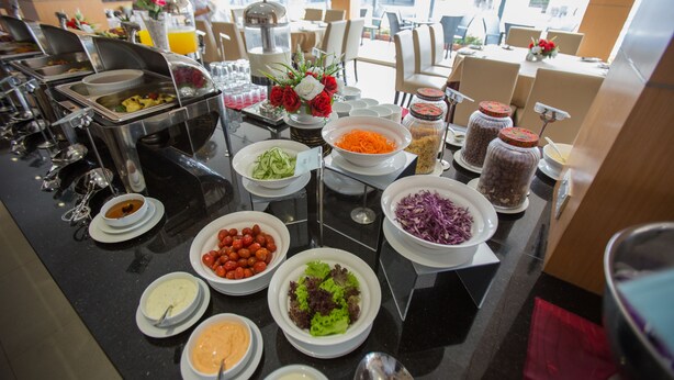A buffet with various food items and condiments. - VIP Hotel Segamat (Segamat)