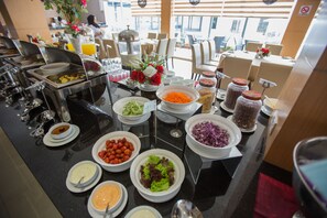 A buffet with various food items and condiments. - VIP Hotel Segamat (Segamat)