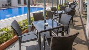 A covered outdoor area with a pool, seating, and a view of the city. - VIP Hotel Segamat (Segamat)