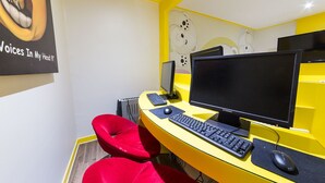 A workspace with two monitors, a keyboard, a mouse, and a red chair. - In Hotel (Suwon)