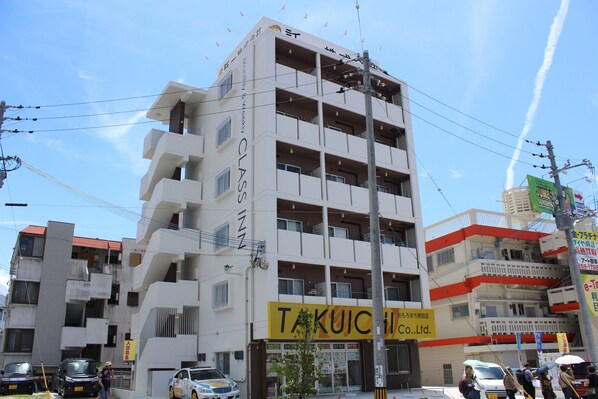 A multi-story building with a sign for "TAKUICHI Co., Ltd."