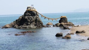 A rocky coastal landscape with a rope bridge connecting two rock formations. - Ama no shima (Toba)