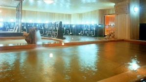 A hot spring bath area with multiple soaking tubs and a wooden interior. - Ama no shima (Toba)