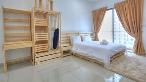 A bedroom with a wooden bed frame, a wooden wardrobe, a small table, and a large window with curtains. - Cybersquare B2210 (Cyberjaya)