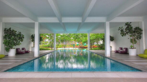 A modern indoor swimming pool with a clear view of a children's play area in the background. - Cybersquare B2210 (Cyberjaya)