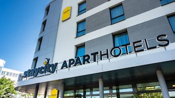 A Staycity Apartments building with a modern design, featuring large windows and a clear sky.