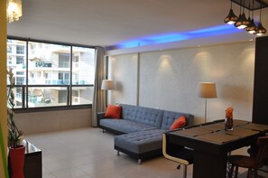 Appartement, 2 chambres, en front de plage | Coin séjour | Télévision à écran plat