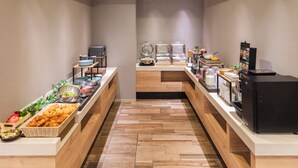 A buffet setup with various food items and a coffee machine. - Sotetsu Fresa Inn Tokyo-Kanda (Tokyo)