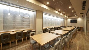 A conference room with long tables and chairs, large windows with blinds, and a flat-screen TV on the wall. - Sotetsu Fresa Inn Tokyo-Kanda (Tokyo)