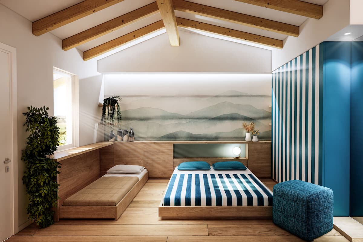 A modern bedroom with a sloped ceiling, a bed with striped bedding, a bench, a small stool, and a wall-mounted TV.