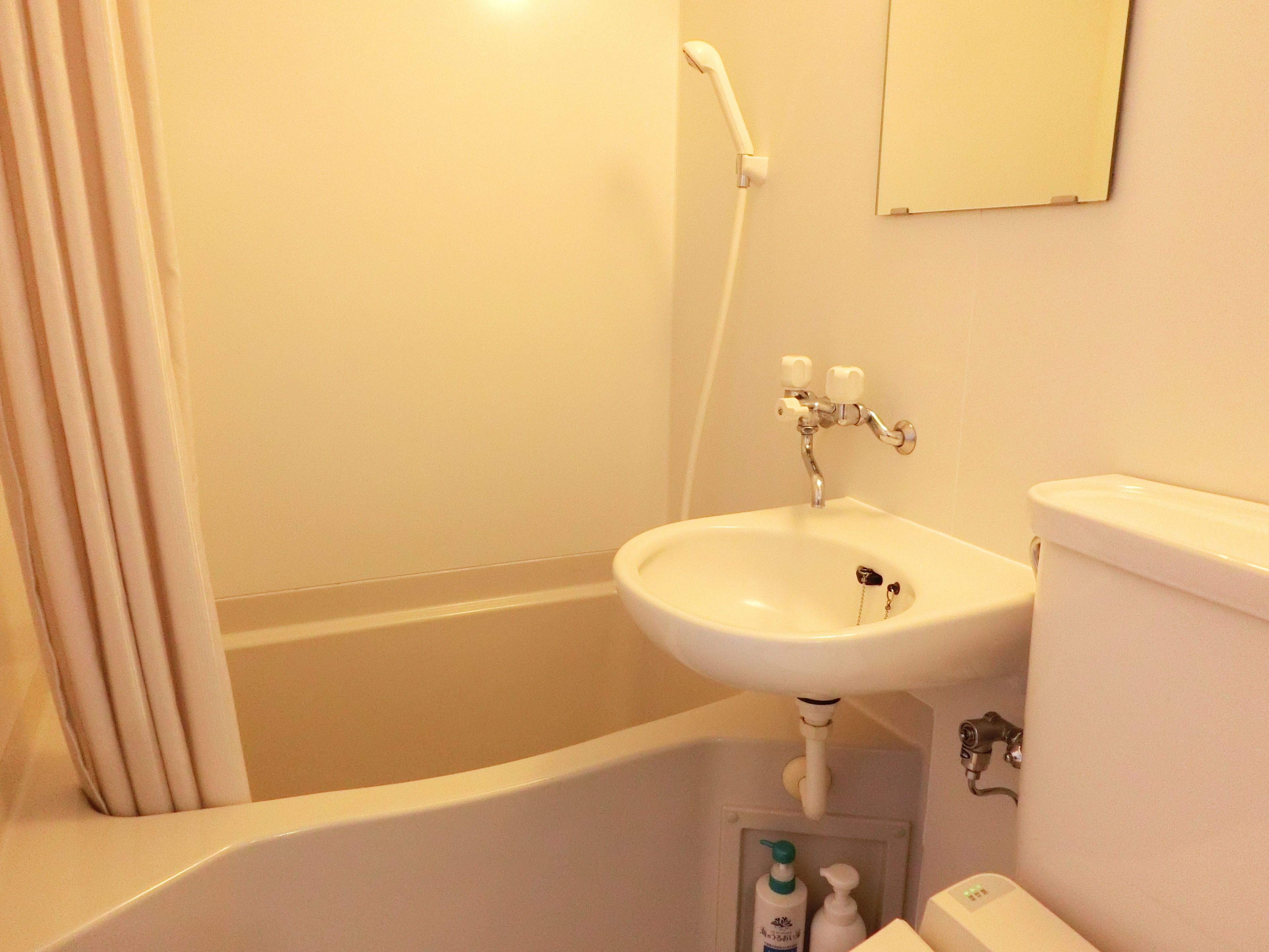 A bathroom with a bathtub, a sink, and a toilet.