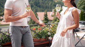 A couple standing on a balcony with a mountainous landscape in the background. - Hotel Marica (Nova Ponente)