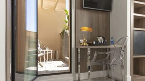 A modern kitchen with a glass partition, a yellow lamp, and a refrigerator. - Hotel Oasis (Barcelona)
