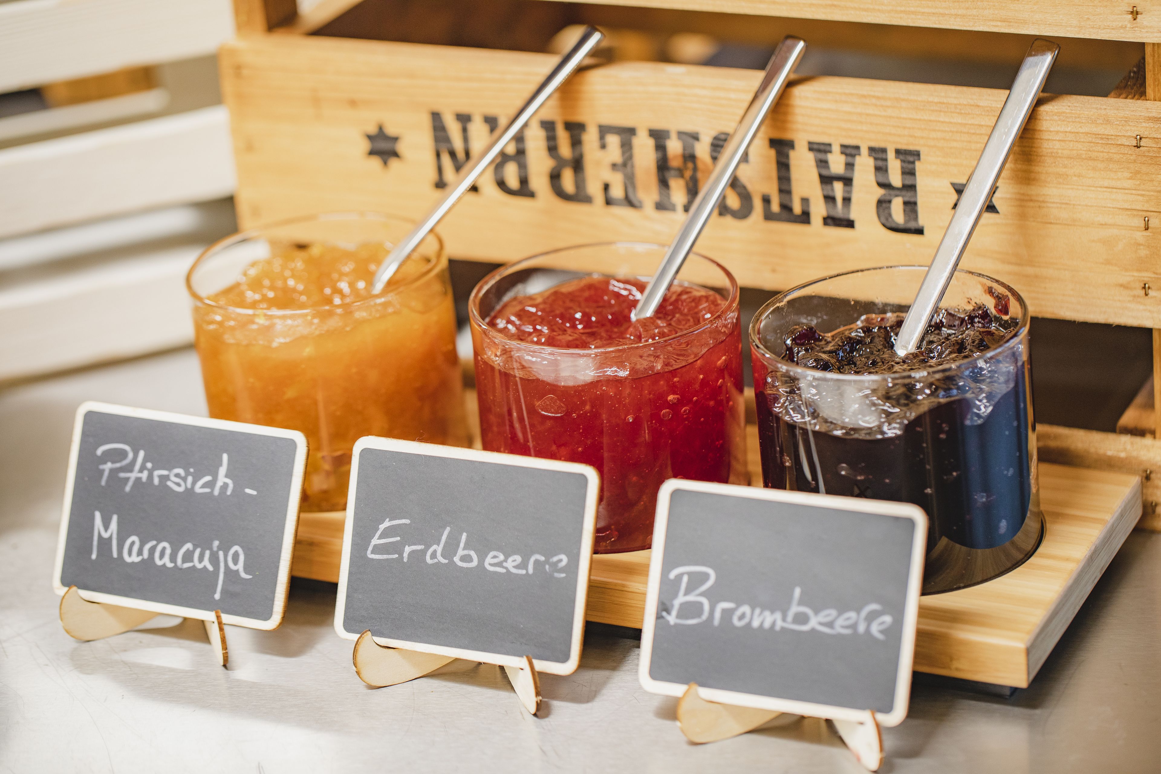 Tres bebidas con pajitas y sus nombres escritos en pequeñas pizarras.