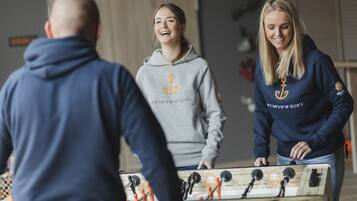 A group of people playing foosball.
