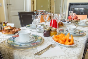 A dining table set with plates, cutlery, and various food items. - B&B Antico Cortile (Milan)