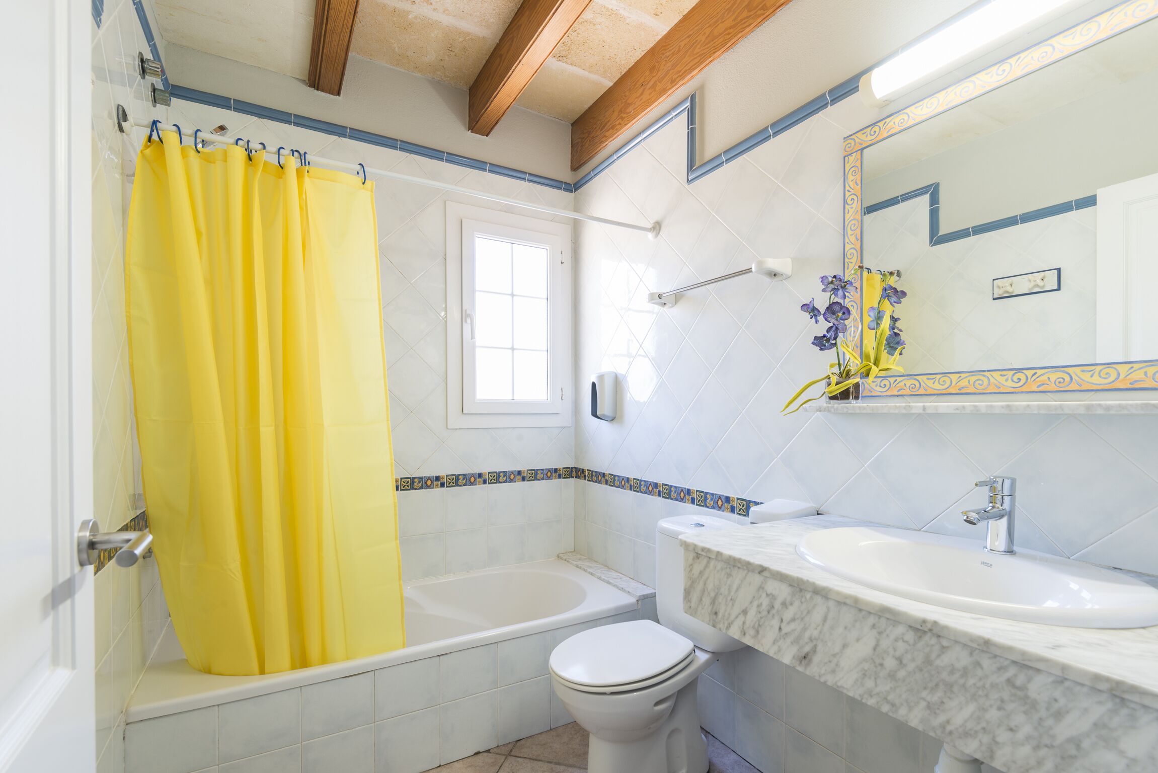A bathroom with a bathtub, toilet, and sink.