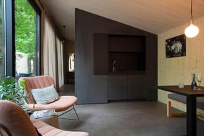 A modern interior with a seating area, a built-in kitchen, and a dining table. - B&B Adelaerthoeve (Arnhem)