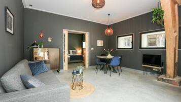 Design Studio Suite, 1 King Bed, Garden View, Ground Floor | Living area | Flat-screen TV