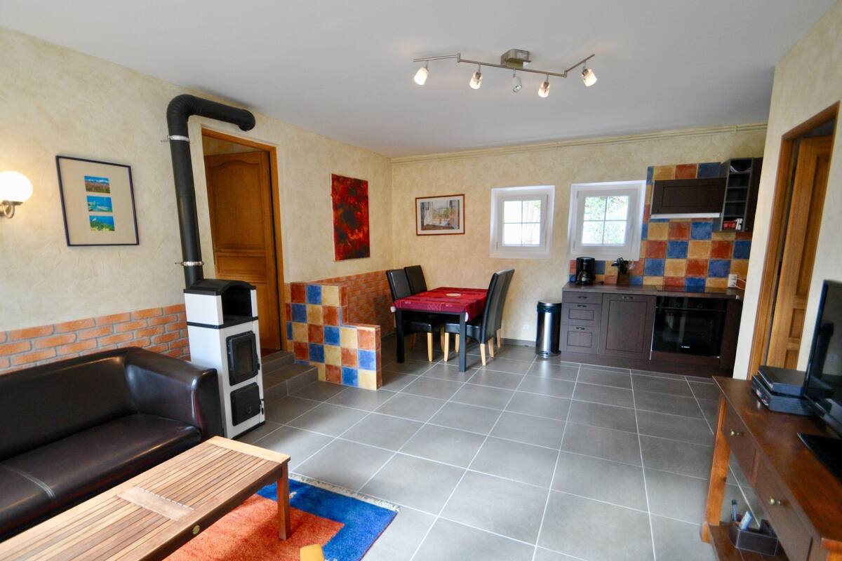 A compact living space with a kitchen, dining area, and seating area.