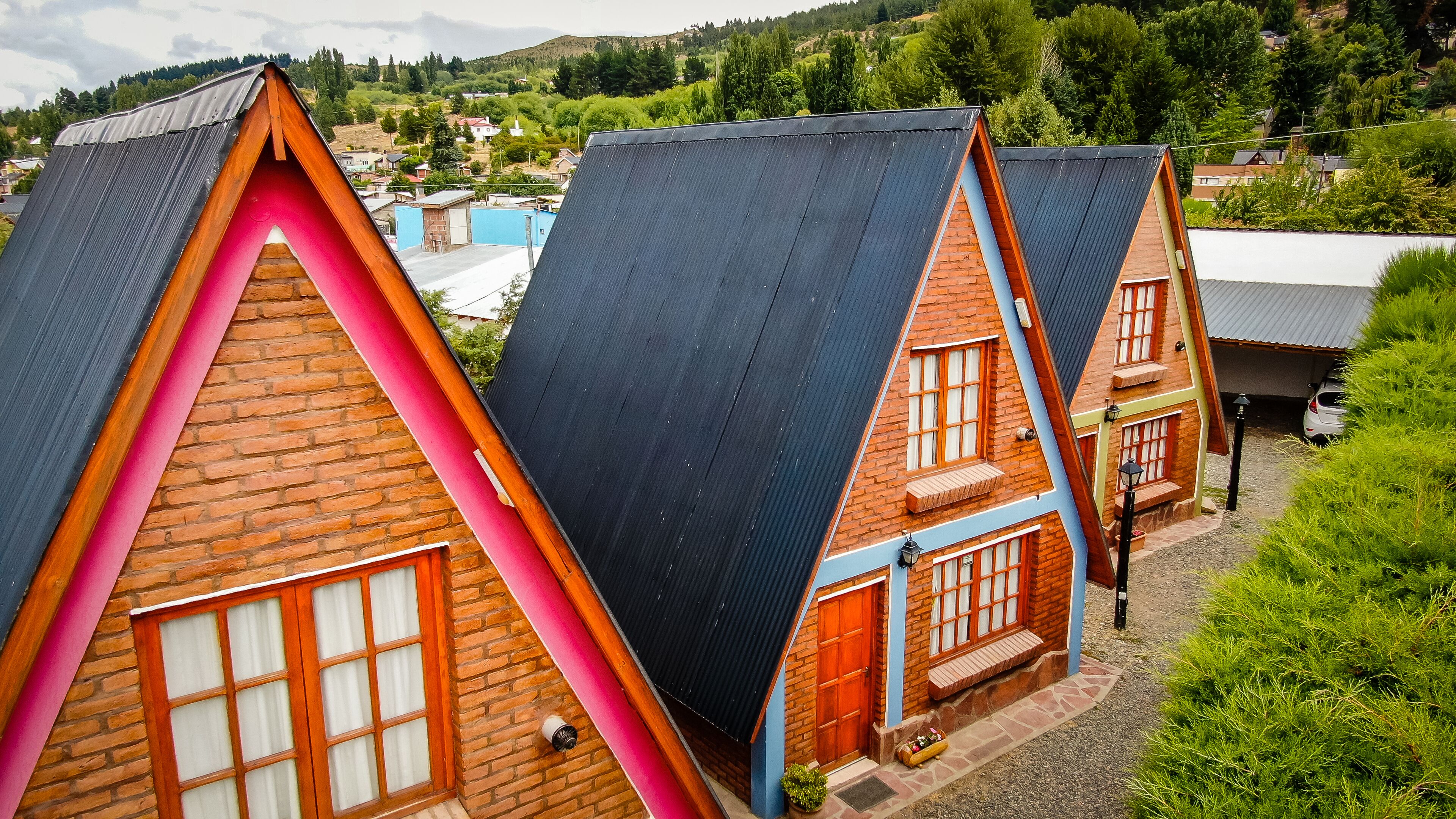 A row of traditional houses with steeply pitched roofs and wooden facades.