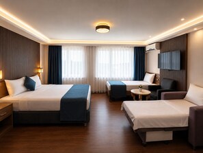 A hotel room with two beds, a TV, a desk, and a chair. - Genius Hotel Istanbul (Istanbul)