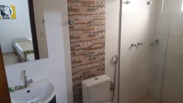 A bathroom with a sink, toilet, and shower.