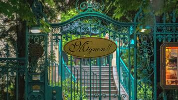 A wrought iron gate with a sign reading "Mignon".