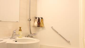 Combined shower/tub, free toiletries, hair dryer, slippers