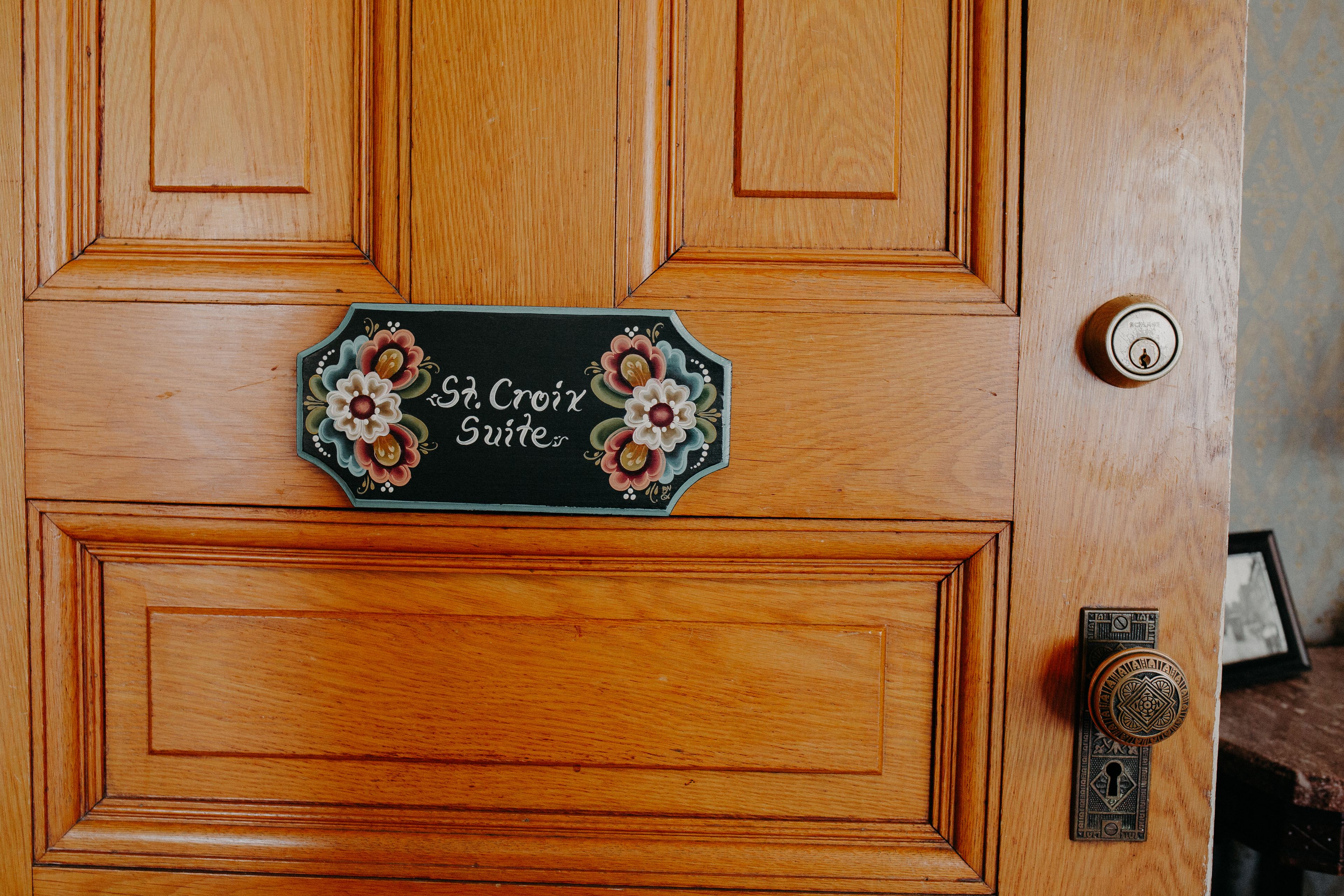 A wooden door with a sign reading "St Croix Suites".