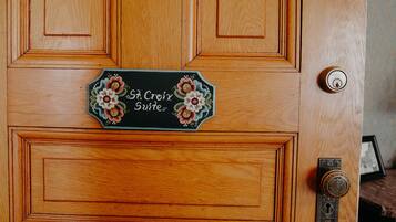 A wooden door with a sign reading "St Croix Suites".