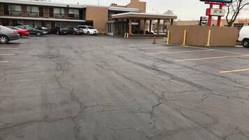 A Travel Inn with a parking lot, a covered entrance, and a building with multiple floors.