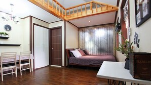 A bedroom with a wooden ceiling, a bed, a desk, and a chair. - Duo Pension (Pyeongchang)