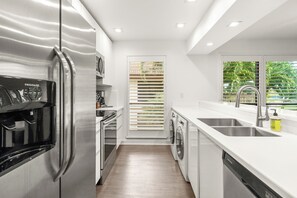 Fridge, microwave, oven, stovetop - Restoration Hardware PGA National Condo w/ 180° Golf Course Views (Palm Beach Gardens)