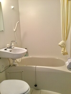 A bathroom with a sink, toilet, and bathtub.