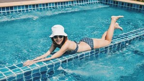 A person lying on a tiled pool edge. - Tubtim Siam River Kwai Resort (Kanchanaburi)