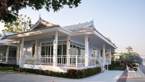 A traditional building with a covered porch and a staircase leading to the entrance. - Tubtim Siam River Kwai Resort (Kanchanaburi)