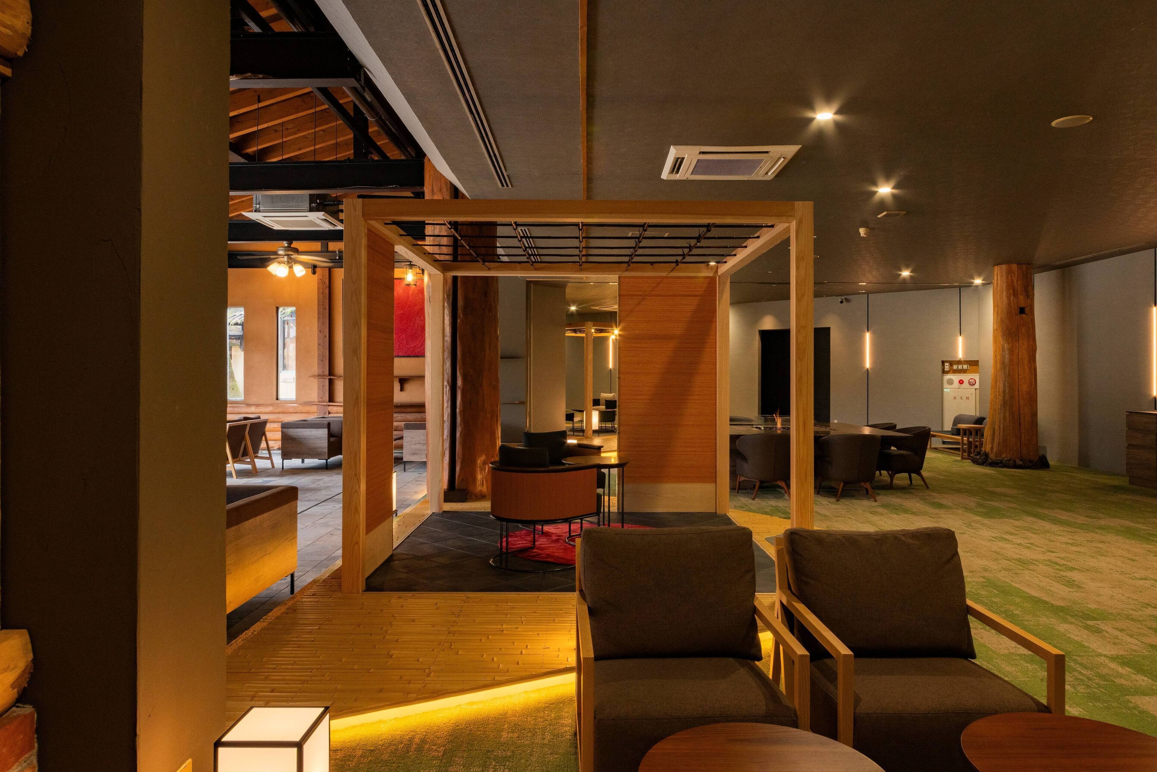 A modern interior with a wooden partition, seating area, and a dining space.