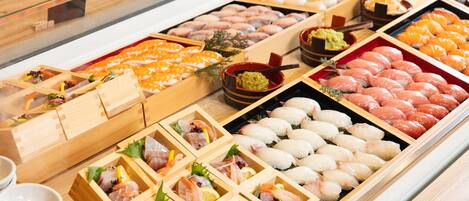 A variety of sushi displayed in wooden boxes and trays.