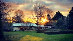 A house with a large front yard and a garage. - The Waterlily Gardens (Waihi)