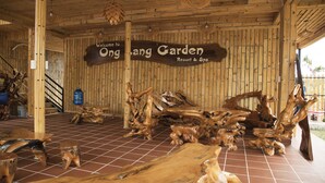 A wooden interior with a sign reading "Welcome to Ongang Garden Resort & Spa."