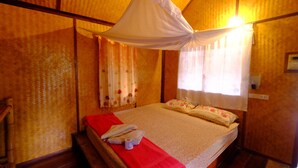 A room with a bed, a red blanket, a white canopy, and floral curtains. - Seaside Resort Koh Lipe (Koh Lipe)