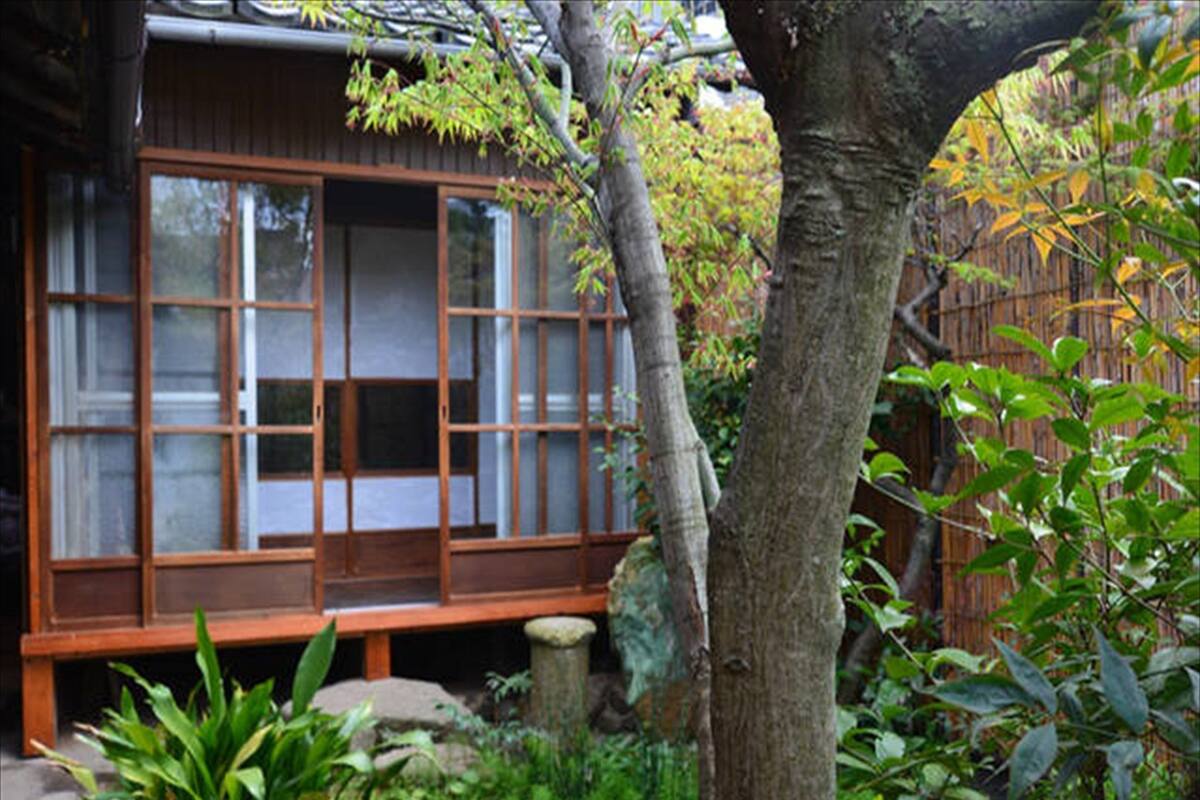 A traditional Japanese-style building with sliding doors and a wooden deck.