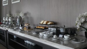 A buffet setup with various food items and serving dishes. - Rivoli Hotel Jakarta (Jakarta)