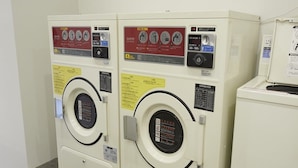 Two white front-loading washing machines with control panels and safety instructions. - IN FRAME HOSTEL enoshima - Hostel (Fujisawa)