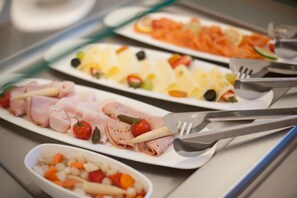 A buffet with various food options including sliced meats, cheeses, and vegetables. - Gabrium (Maria Enzersdorf)